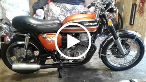 Gordon’s orange Honda CB motorcycle in his workshop